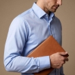 Close-up view of blue formal shirt collar and fabric