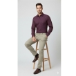 Man sitting wearing maroon formal shirt and beige trousers