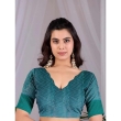 teal blouse with off-white printed lichi silk saree