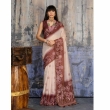Woman wearing cream and brown Munga cotton handloom saree with woven border