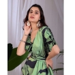 Woman Posing in Pista Green and Black Printed Satin Georgette Saree