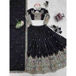 Close-up view of embroidery sequence work on black lehenga fabric