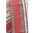Close-up of white and red Dhaniakhali saree fabric highlighting traditional cotton weave and handloom detailing