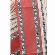 Close-up of white and red Dhaniakhali saree fabric highlighting traditional cotton weave and handloom detailing