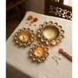 Set of three brass finish urli bowls in different sizes for home decoration