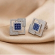 Gold-tone square stud earrings featuring brilliant sapphire blue stones