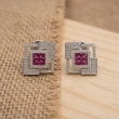 Close-up of ruby pink square geometric stone stud earrings with elegant finish