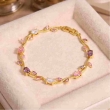 Gold plated tulip bracelet with purple and pink floral detailing